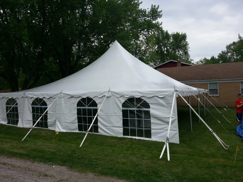 40x40 Century-style white tent set up beside a house on a grassy lawn